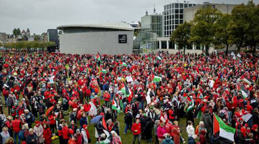 Grote toestroom van in het rood geklede mensen naar Museumplein